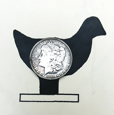 Chicken silhouette compared to a silver dollar.